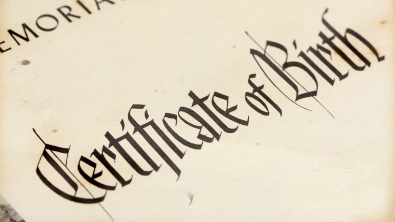 Close up of a Birth Certificate to the words Certificate of Birth