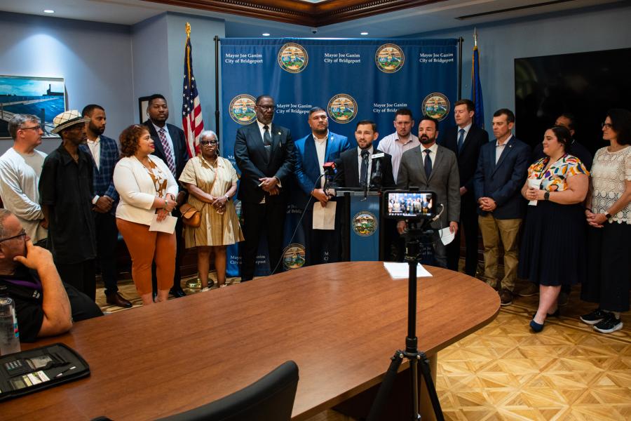 Photo of Bridgeport Delegation, Comptroller Sean Scanlon, Members of Bridgeport City Council, and Mayor Ganim during a press conference to announce legislative updates and pension plan reforms
