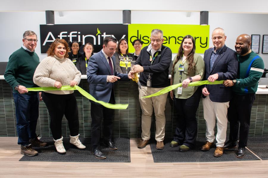 Photo of Mayor Ganim, City Councilwoman Aidee Nieves, Ray Pantalena (owner of Affinity Dispensary), and other staff cutting a green ribbon at the Affinity Dispensary grand opening