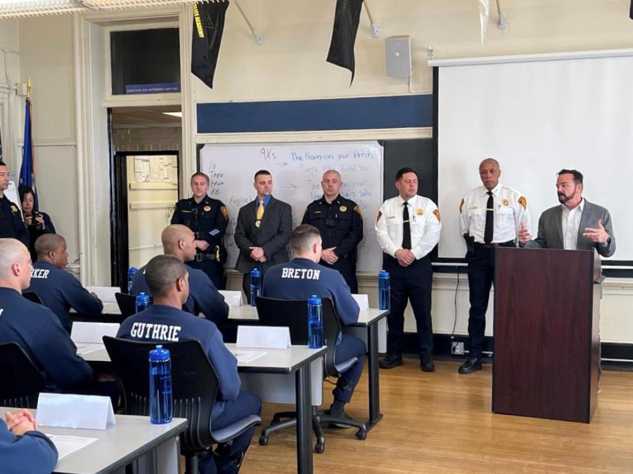 Photo of Mayor Ganim standing next to Chief Porter and other Bridgeport Police Officers as he speaks to class 45 at the Bridgeport Police Academy.