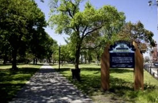 Public park with trees, paths, and "Welcome" sign