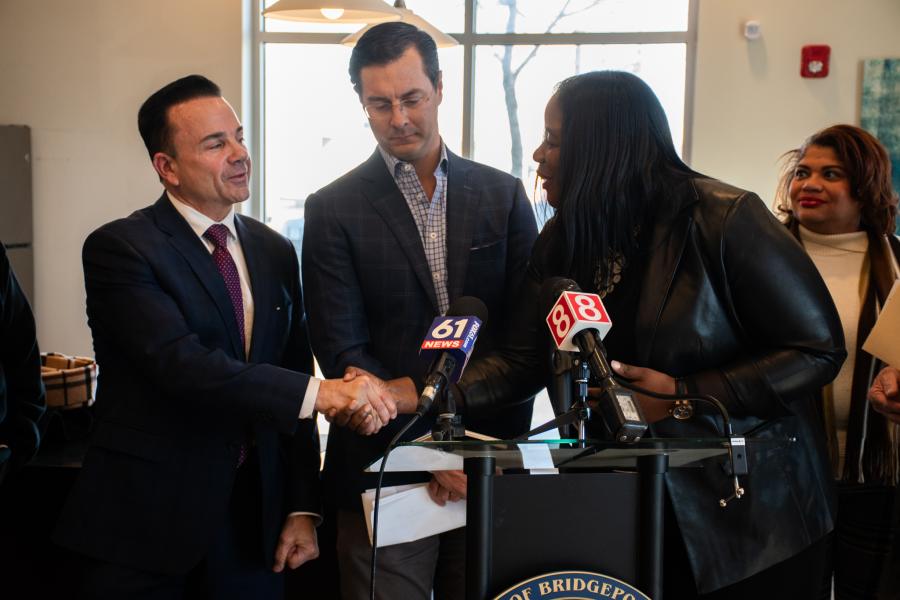 Photo of Mayor Ganim and Jillian Baldwin shaking hands at the Park City Communities Phase III Press Conference for Crescent Crossings